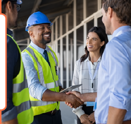 An image of a group of people, some wearing high vis jackets and hard hats, shaking hands