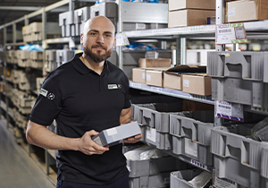 Image of someone in a warehouse holding a box